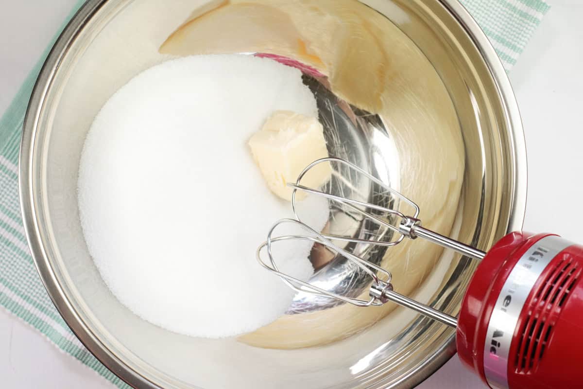 beating sugar and butter in a bowl