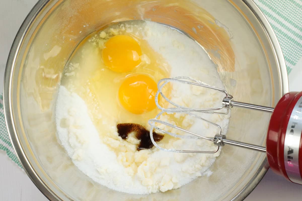 adding in eggs and vanilla to butter and sugar 