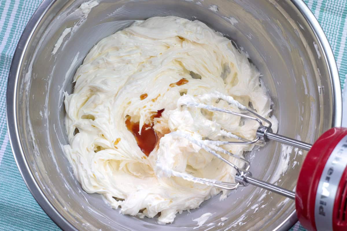 vanilla extract being added to frosting