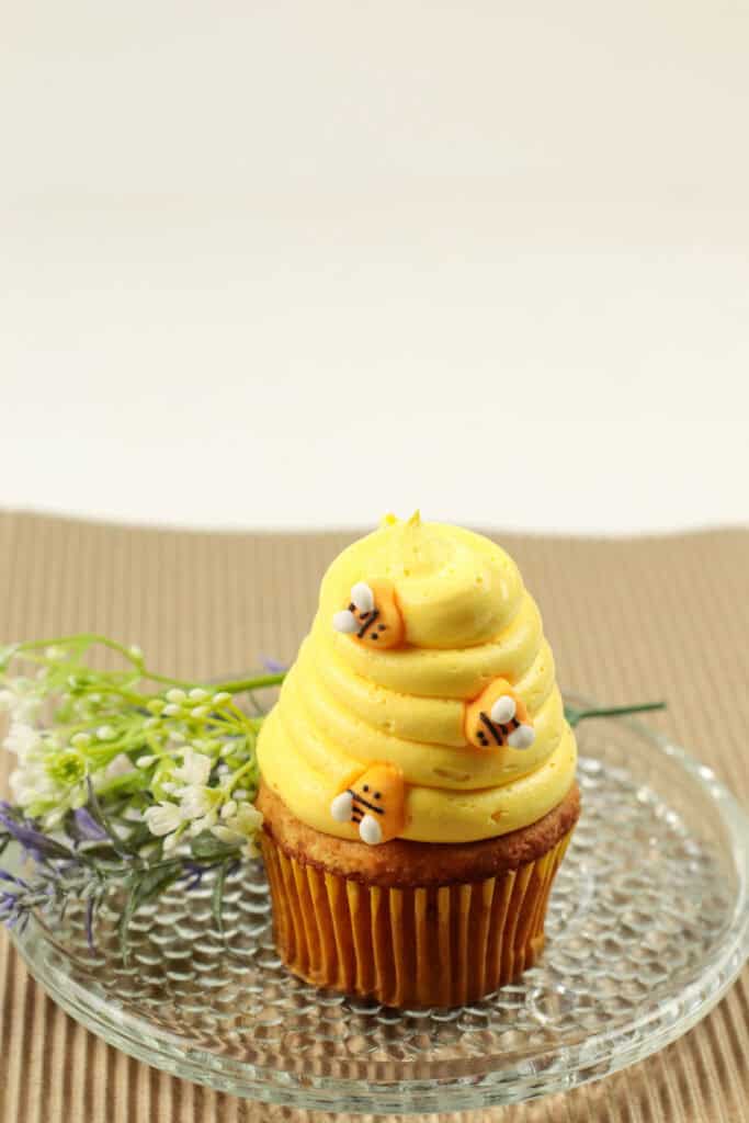 yellow iced winnie the pooh cupcakes topped with three edible bees