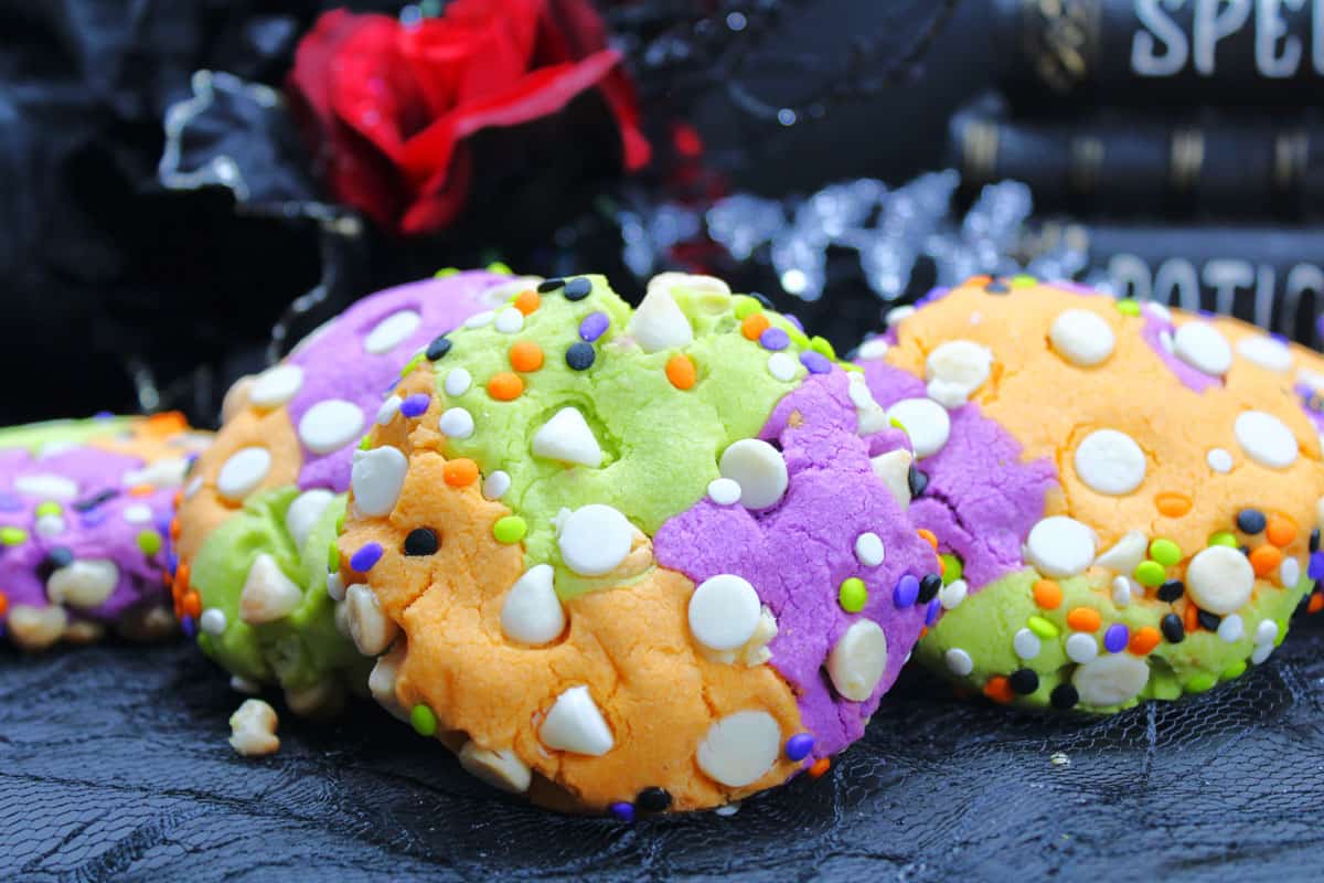 three colored cookies with sprinkles and white chocolate chips