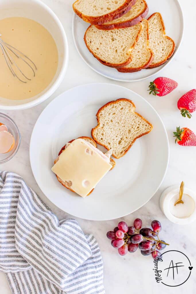 making gluten free sandwich with swiss cheese, turkey and ham. 